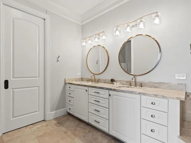 a bathroom with a double vanity sink and a mirror