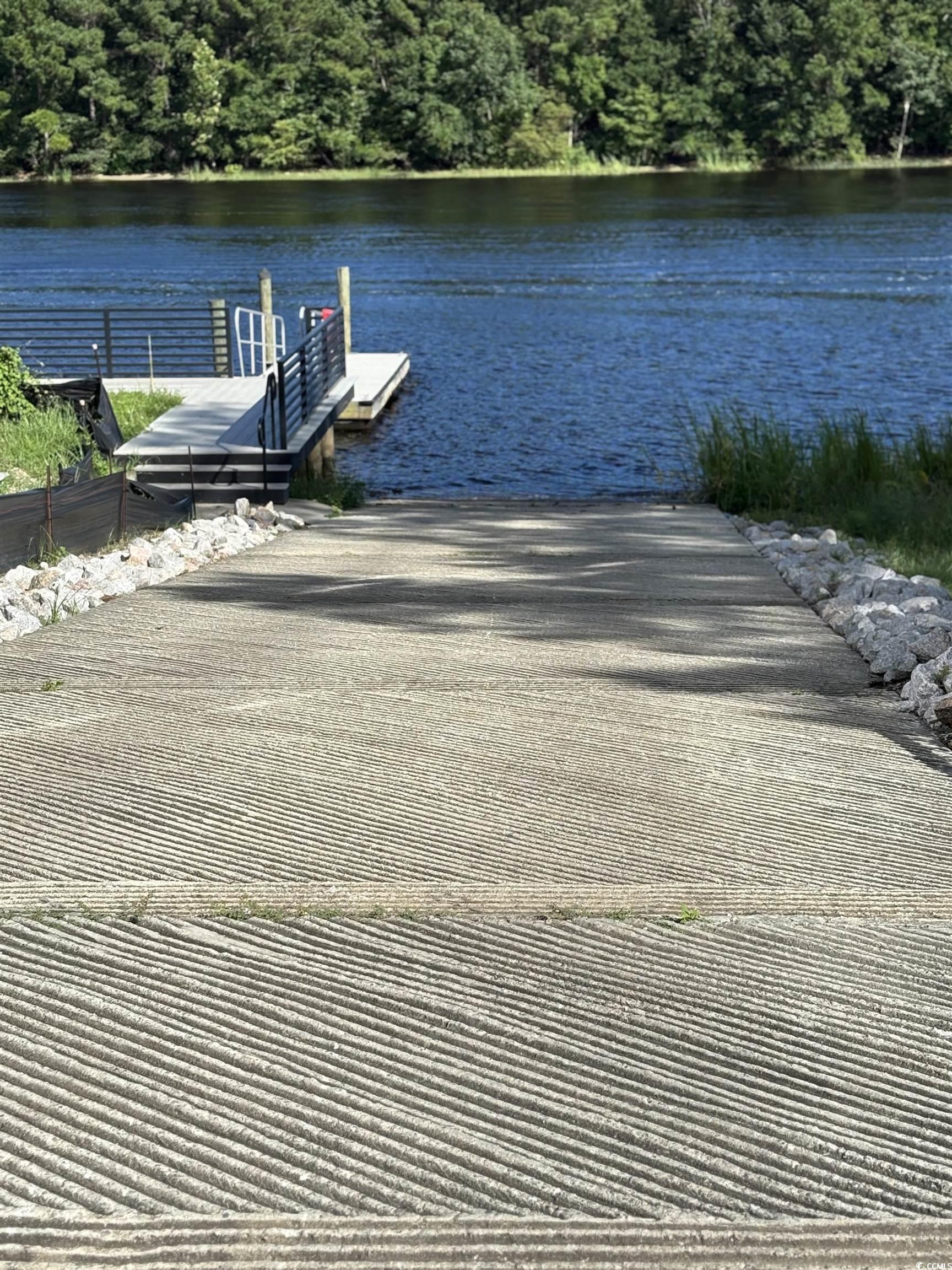 450 Harbour View Drive Myrtle Beach, SC 29579 - Photo 15 of 15 Dock area with a boat ramp, a water view, and a view of trees