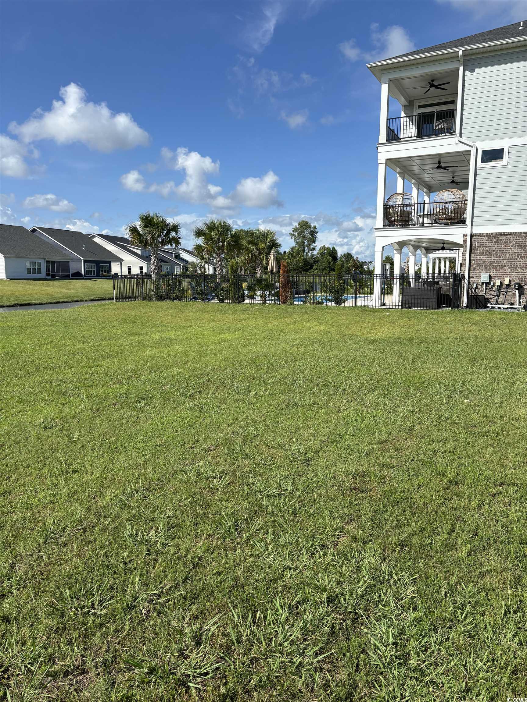 450 Harbour View Drive Myrtle Beach, SC 29579 - Photo 6 of 15 View of yard featuring a ceiling fan and a balcony