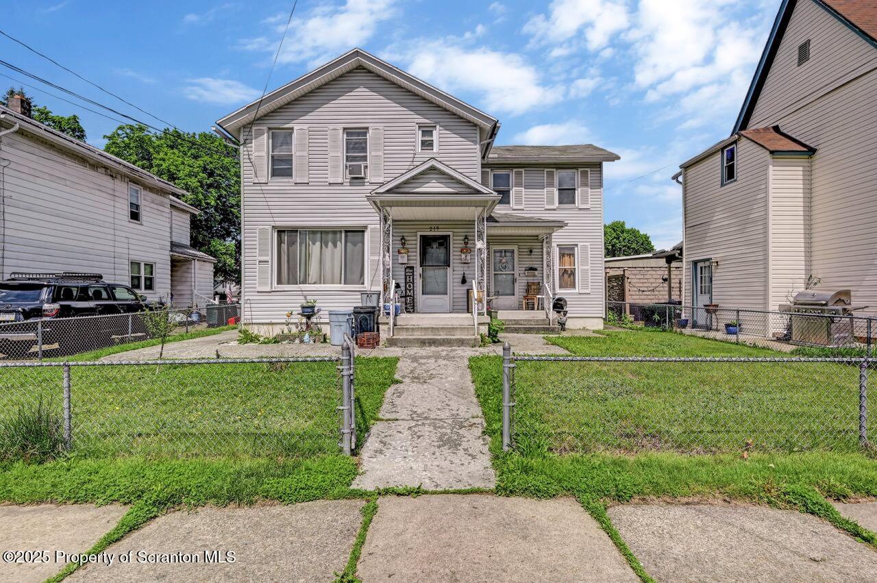 a front view of a house with a garden and patio