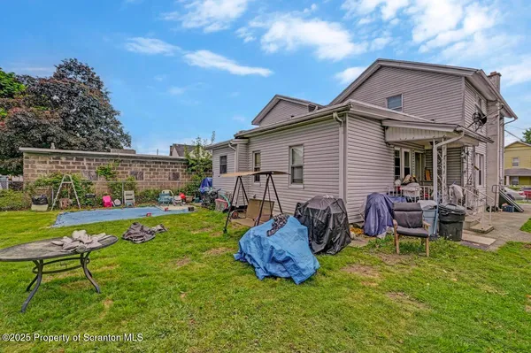a view of an outdoor sitting area in a backyard