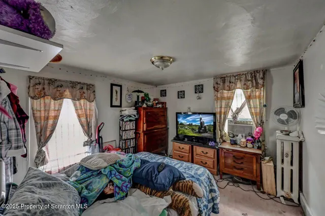 a front view of a house with swimming pool having outdoor seating