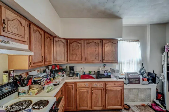 a view of a hallway with workspace and a window
