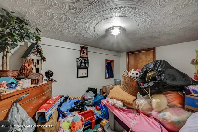 a bed room with furniture and a flat screen tv