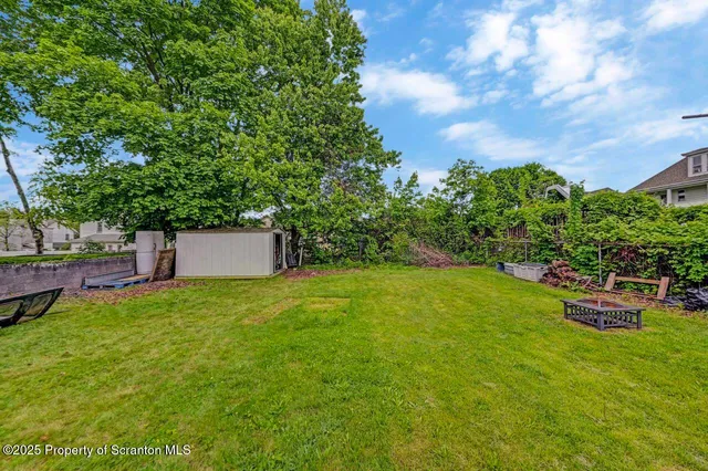 a front view of a house with garden and patio