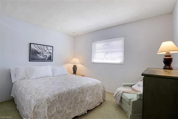 a bedroom with a bed and a table in it