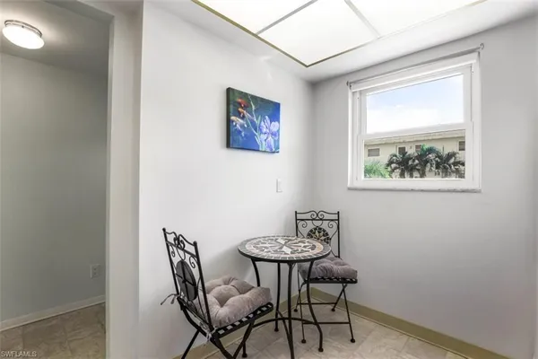 a view of a dining room with furniture and a window