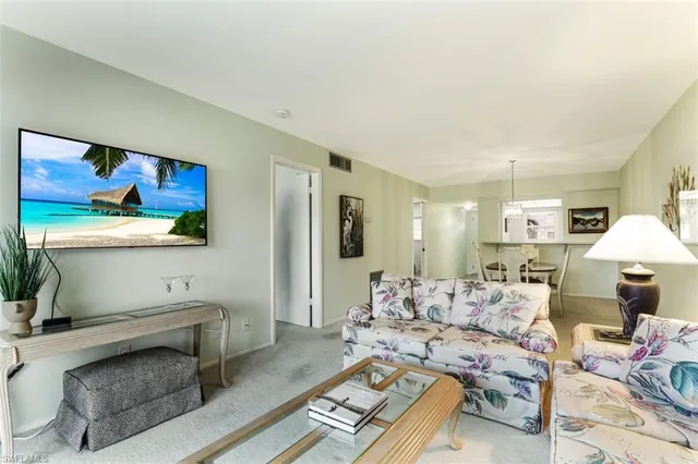 a living room with furniture and a lamp