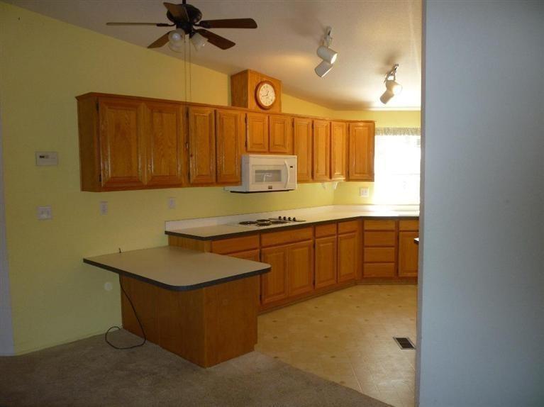 2695 Old Ferry Road Shady Cove, OR 97539 - Photo 28 of 31 Kitchen showing cooktop, clock, fan, and