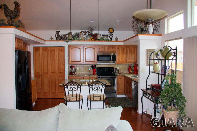353 Belden Court Fruita, CO 81521 - Photo 16 of 16 a kitchen with stainless steel appliances granite countertop a stove and a sink