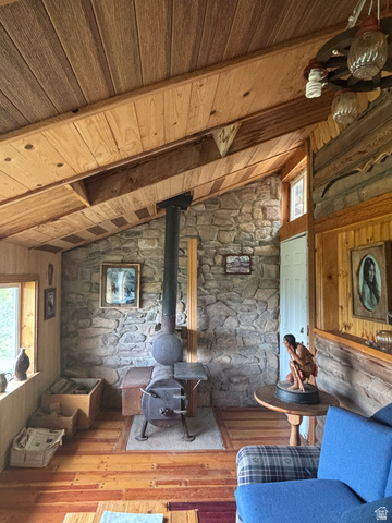 6476 Stauffer Road, Unit 4 Montpelier, ID 83254 - Photo 15 of 17 Interior space featuring a stone accent wall with a prominent wood-burning stove