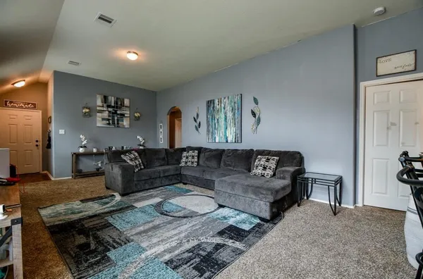 a living room with furniture and wooden floor
