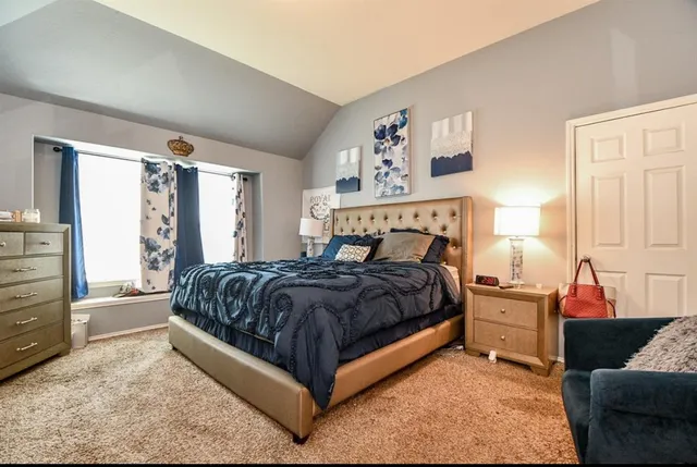 a bedroom with a bed and window