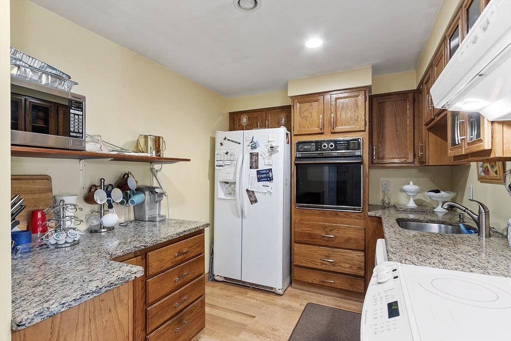 154 Lynnway, Unit 205 Lynn, MA 01902 - Photo 11 of 29 a kitchen with stainless steel appliances granite countertop a refrigerator and a stove top oven