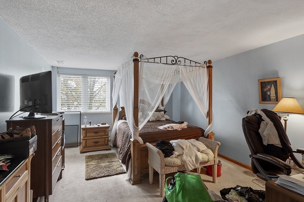 154 Lynnway, Unit 205 Lynn, MA 01902 - Photo 13 of 29 a bedroom with furniture and a window