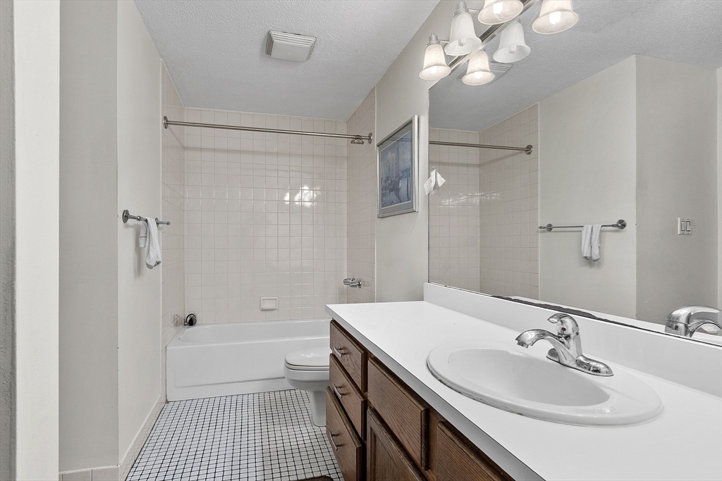 154 Lynnway, Unit 205 Lynn, MA 01902 - Photo 15 of 29 a bathroom with a sink a toilet a shower and a mirror
