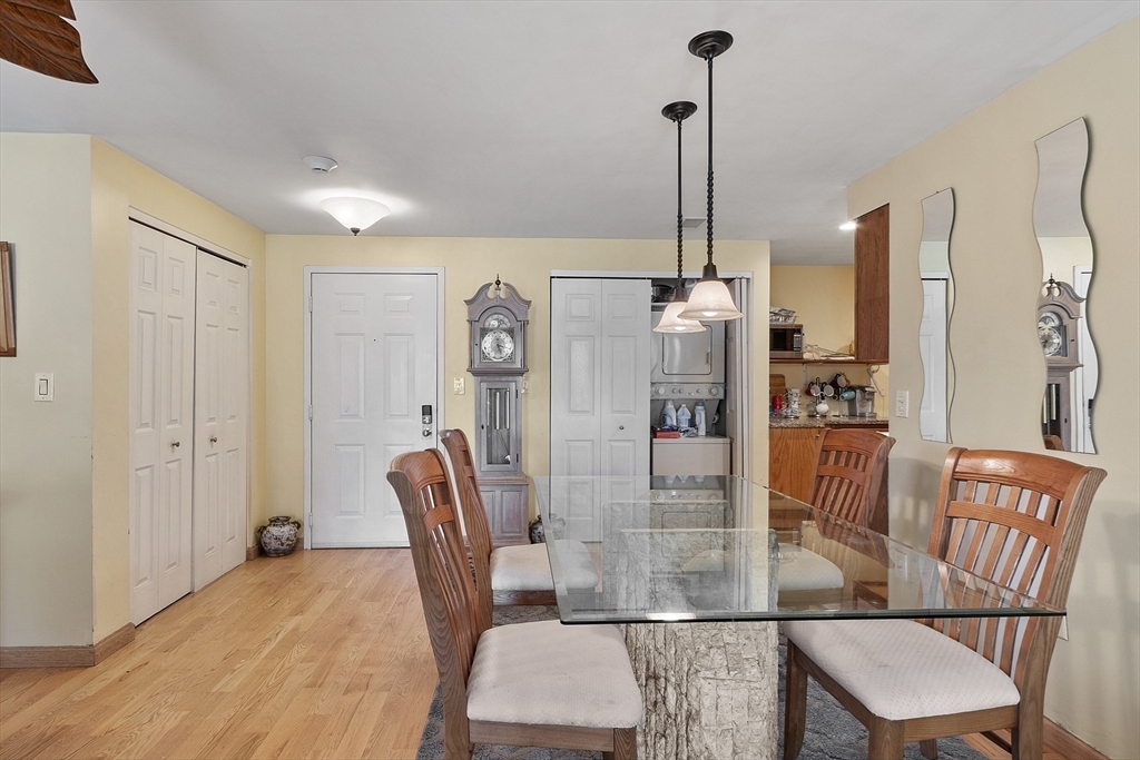 154 Lynnway, Unit 205 Lynn, MA 01902 - Photo 19 of 29 a dining room with furniture and a chandelier