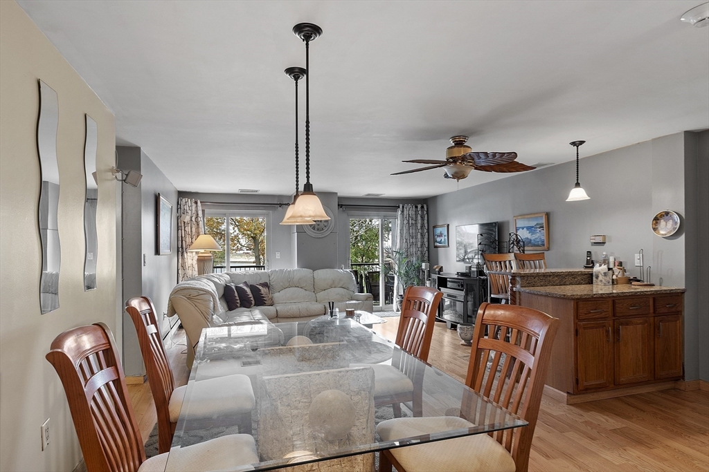 154 Lynnway, Unit 205 Lynn, MA 01902 - Photo 20 of 29 a view of a dining room and livingroom with furniture wooden floor a chandelier