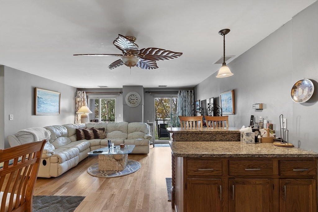 154 Lynnway, Unit 205 Lynn, MA 01902 - Photo 21 of 29 a living room with furniture and a chandelier