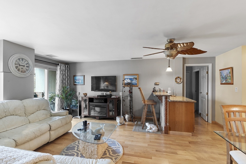 154 Lynnway, Unit 205 Lynn, MA 01902 - Photo 24 of 29 a living room with furniture a flat screen tv and a window