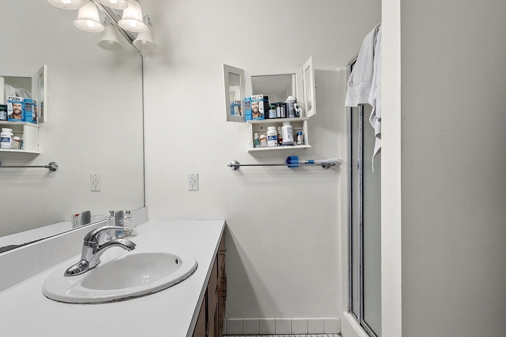 154 Lynnway, Unit 205 Lynn, MA 01902 - Photo 27 of 29 a bathroom with a sink and a mirror