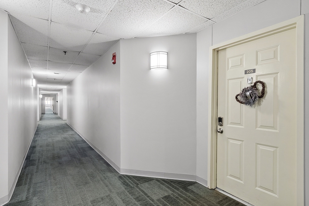 154 Lynnway, Unit 205 Lynn, MA 01902 - Photo 28 of 29 a view of a hallway with a elevator