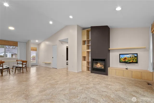 a kitchen with stainless steel appliances granite countertop a refrigerator a sink and a stove