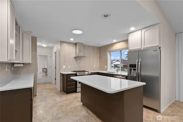 a kitchen with a stove a refrigerator and a sink