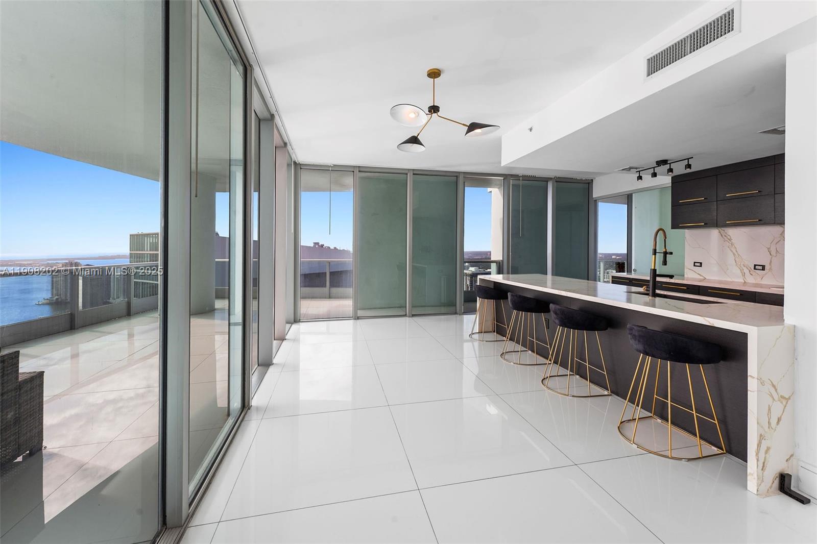 900 Biscayne Boulevard, Unit PH6201 Miami, FL 33132 - Photo 19 of 73 a large kitchen with kitchen island granite countertop a large counter top and stainless steel appliances