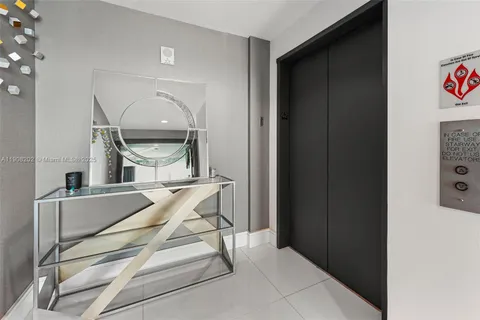 a view of a living room kitchen with stainless steel appliances kitchen island granite countertop a refrigerator and a sink