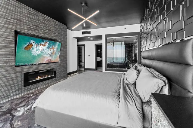 a bedroom with a bed and large window