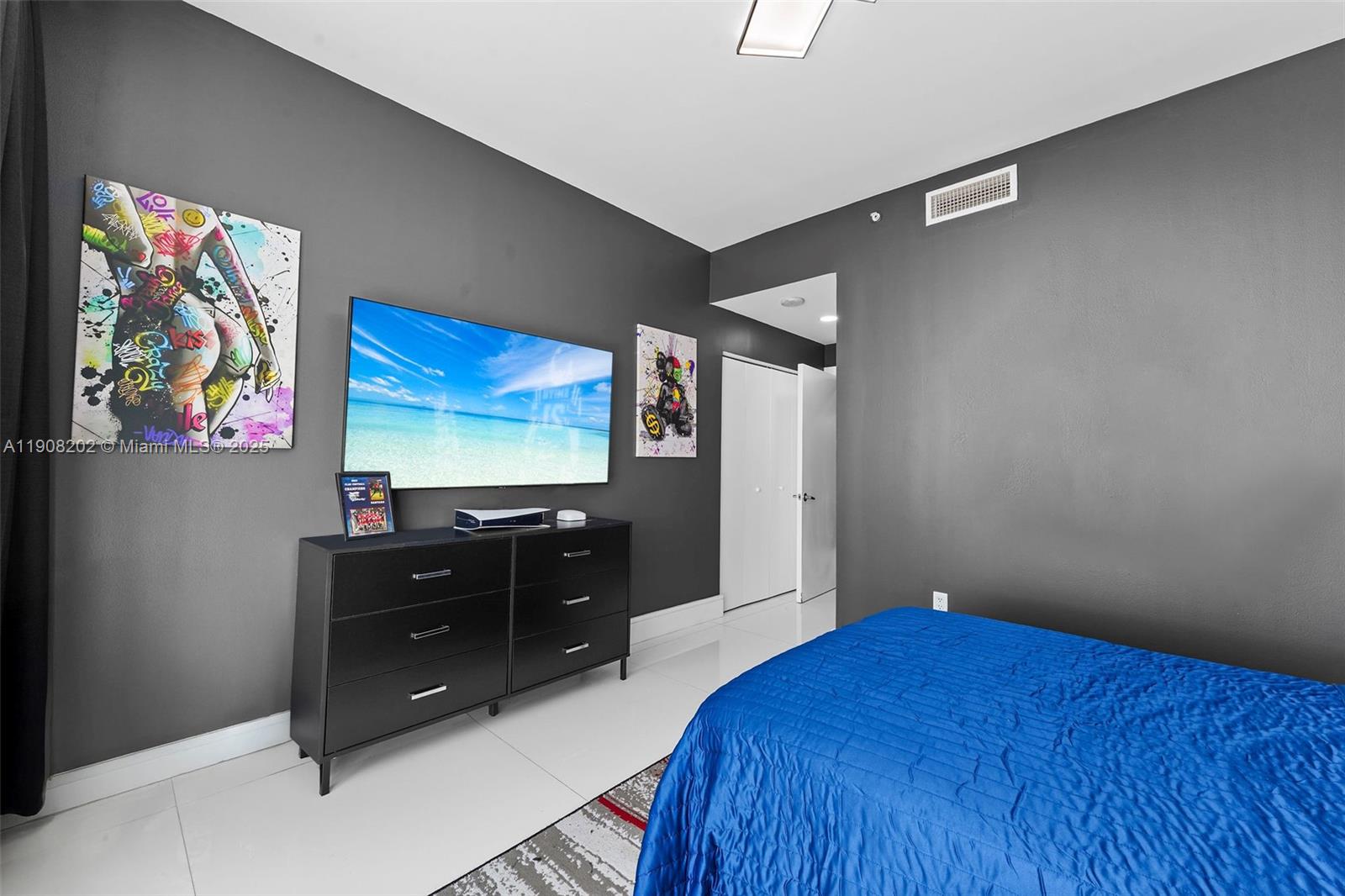 900 Biscayne Boulevard, Unit PH6201 Miami, FL 33132 - Photo 36 of 73 a bedroom with a bed and a flat screen tv