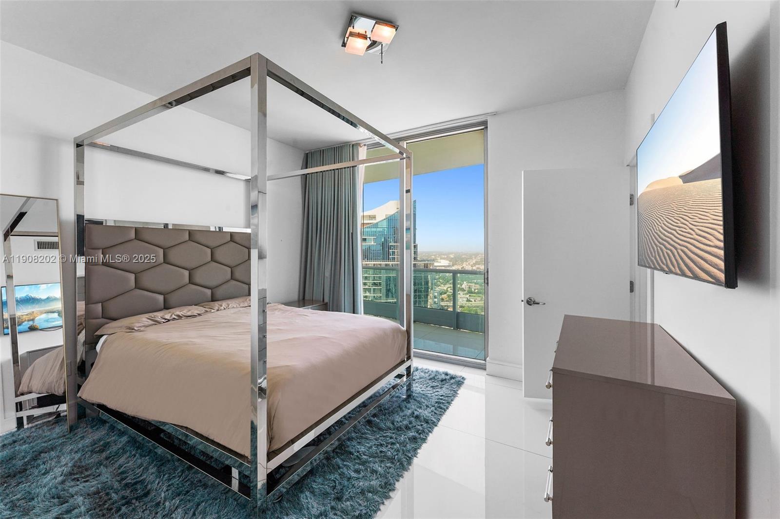 900 Biscayne Boulevard, Unit PH6201 Miami, FL 33132 - Photo 43 of 73 a bedroom with a bed and window