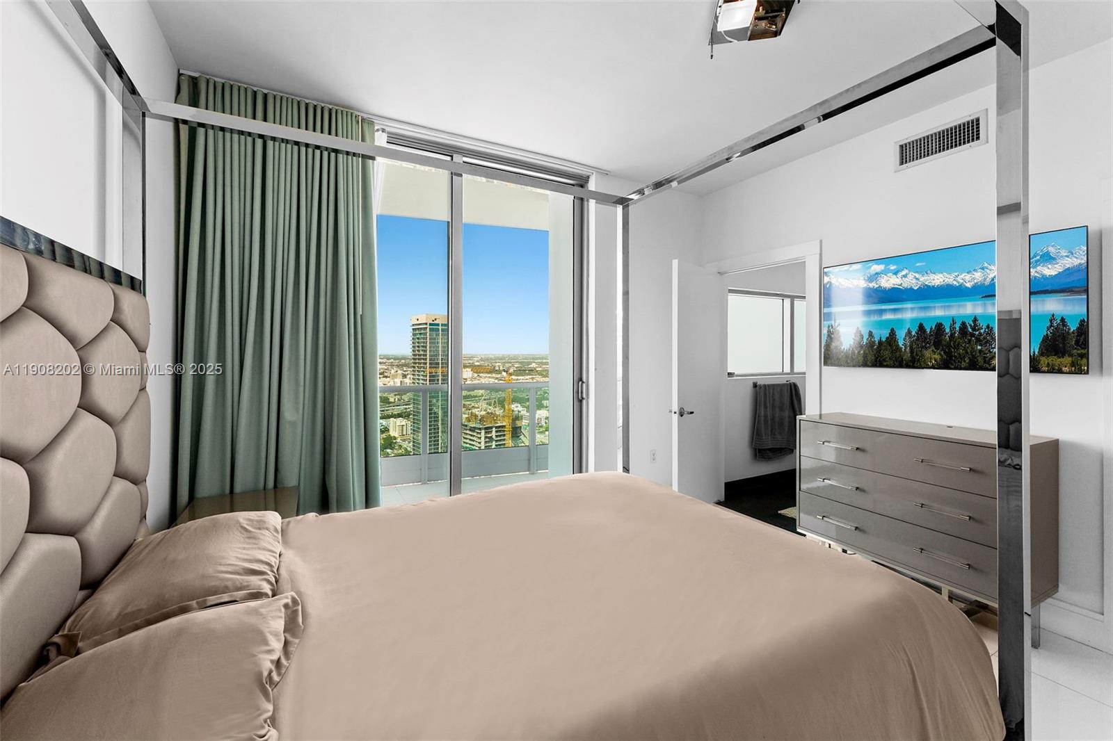 900 Biscayne Boulevard, Unit PH6201 Miami, FL 33132 - Photo 44 of 73 a bedroom with a balcony a bed and a dresser