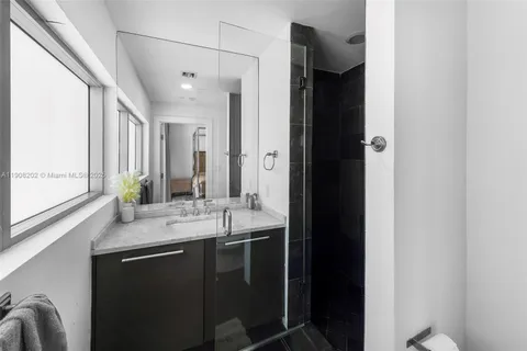 a bathroom with a potted plant and a sink