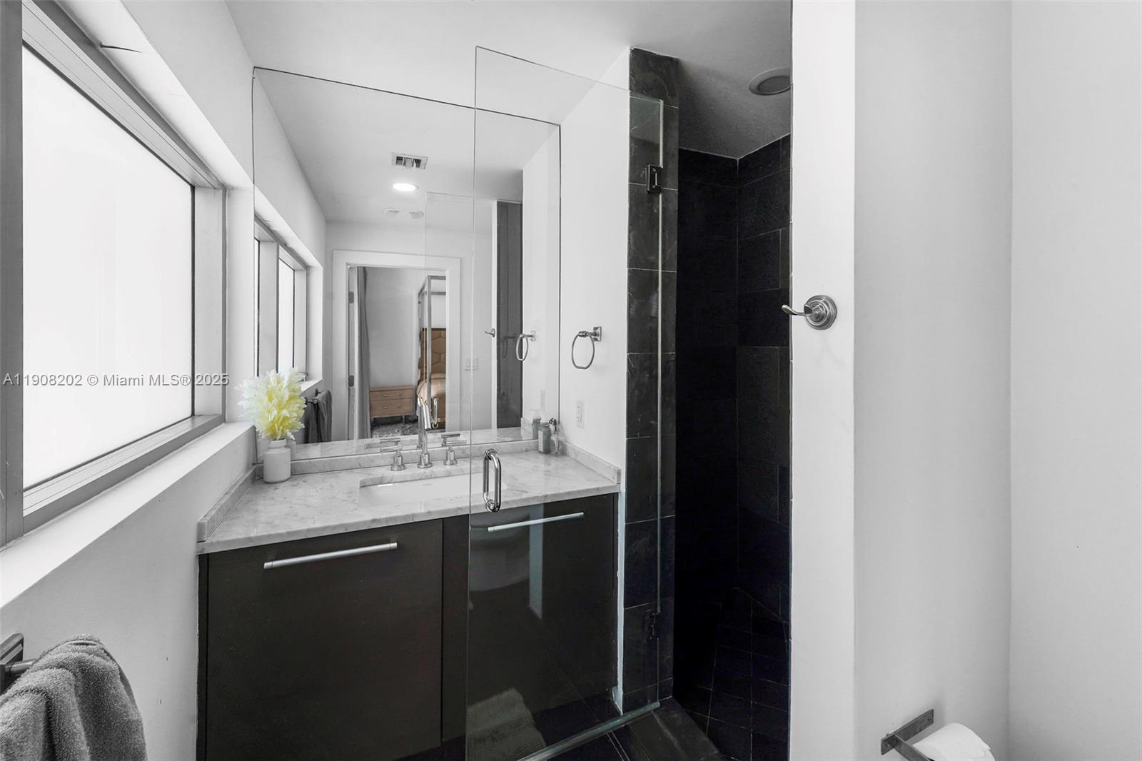 900 Biscayne Boulevard, Unit PH6201 Miami, FL 33132 - Photo 48 of 73 a bathroom with a double vanity sink and a mirror