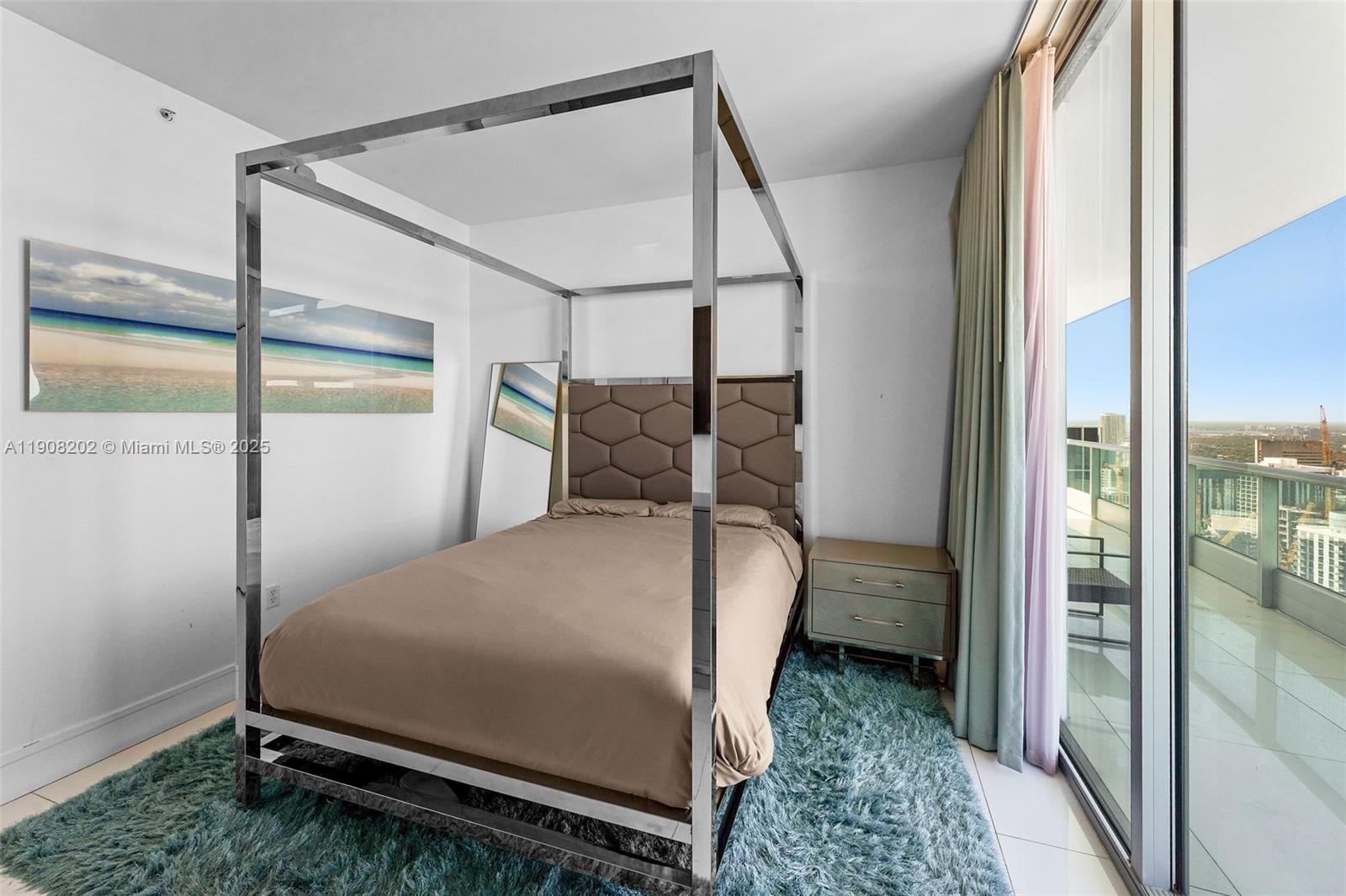 900 Biscayne Boulevard, Unit PH6201 Miami, FL 33132 - Photo 49 of 73 a bed room with a bed and a mirror