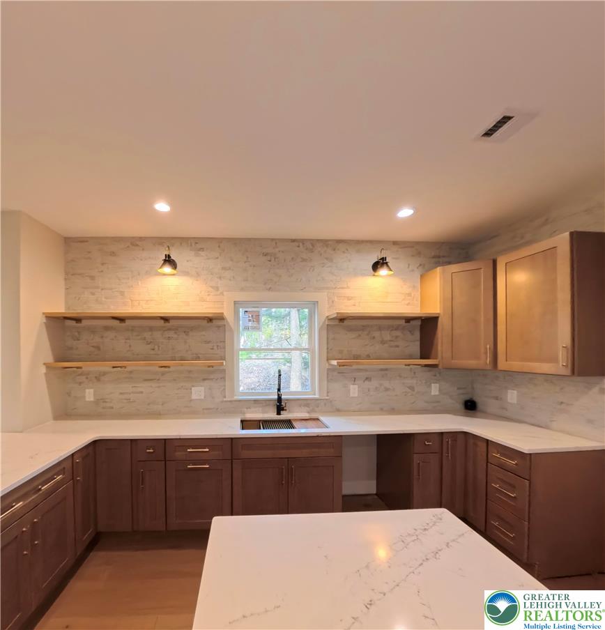 41 South 2nd Street Emmaus, PA 18049 - Photo 9 of 37 a kitchen with stainless steel appliances kitchen island granite countertop a sink and cabinets