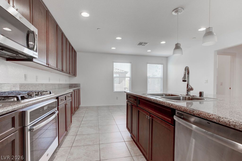 4650 Ranch House Road, Unit 47 North Las Vegas, NV 89031 - Photo 9 of 43 Culinary delights await in this modern kitchen with extensive cabinetry and an inviting island sink.