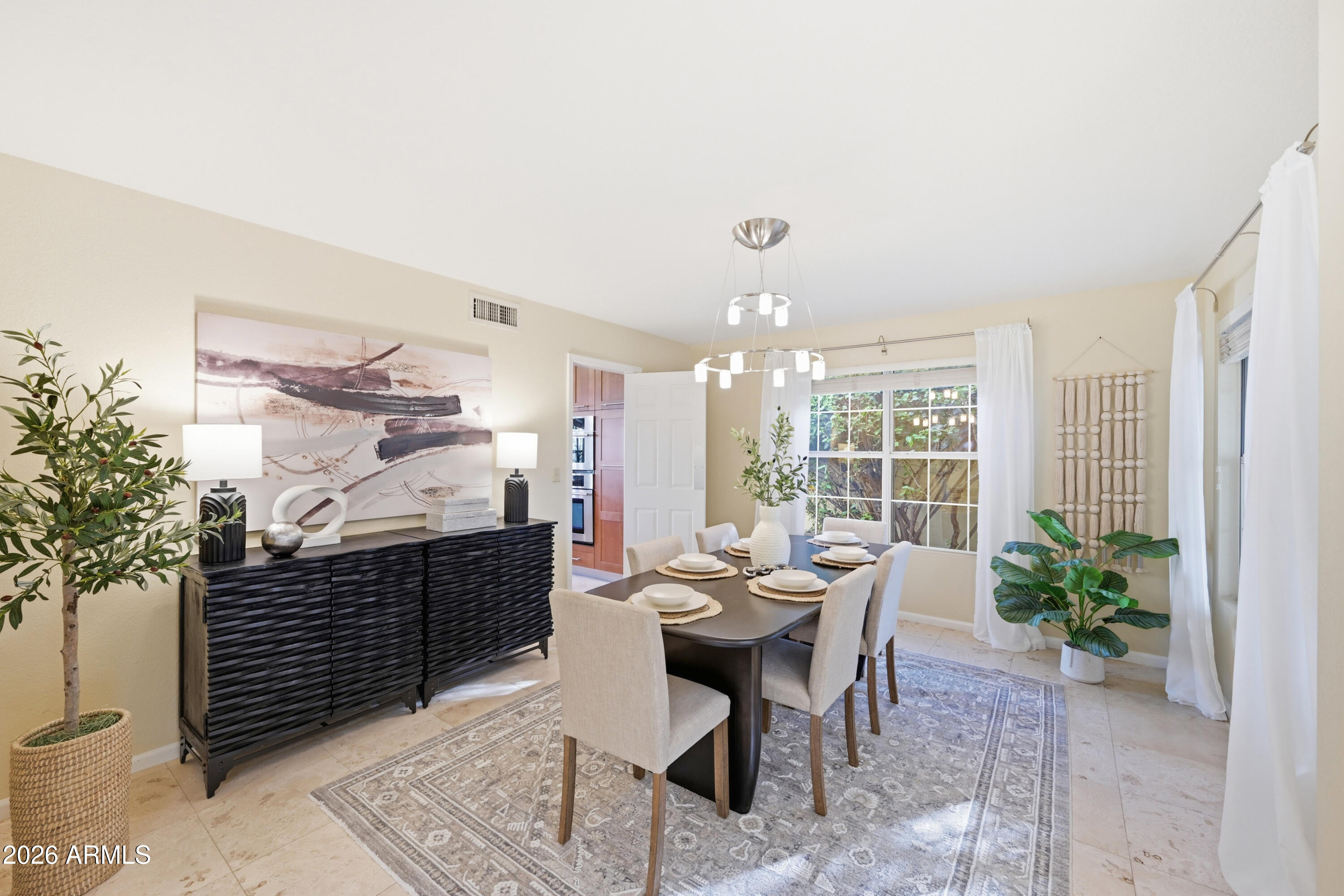 9502 East Presidio Road Scottsdale, AZ 85260 - Photo 12 of 39 a living room with furniture a potted plant and a large window