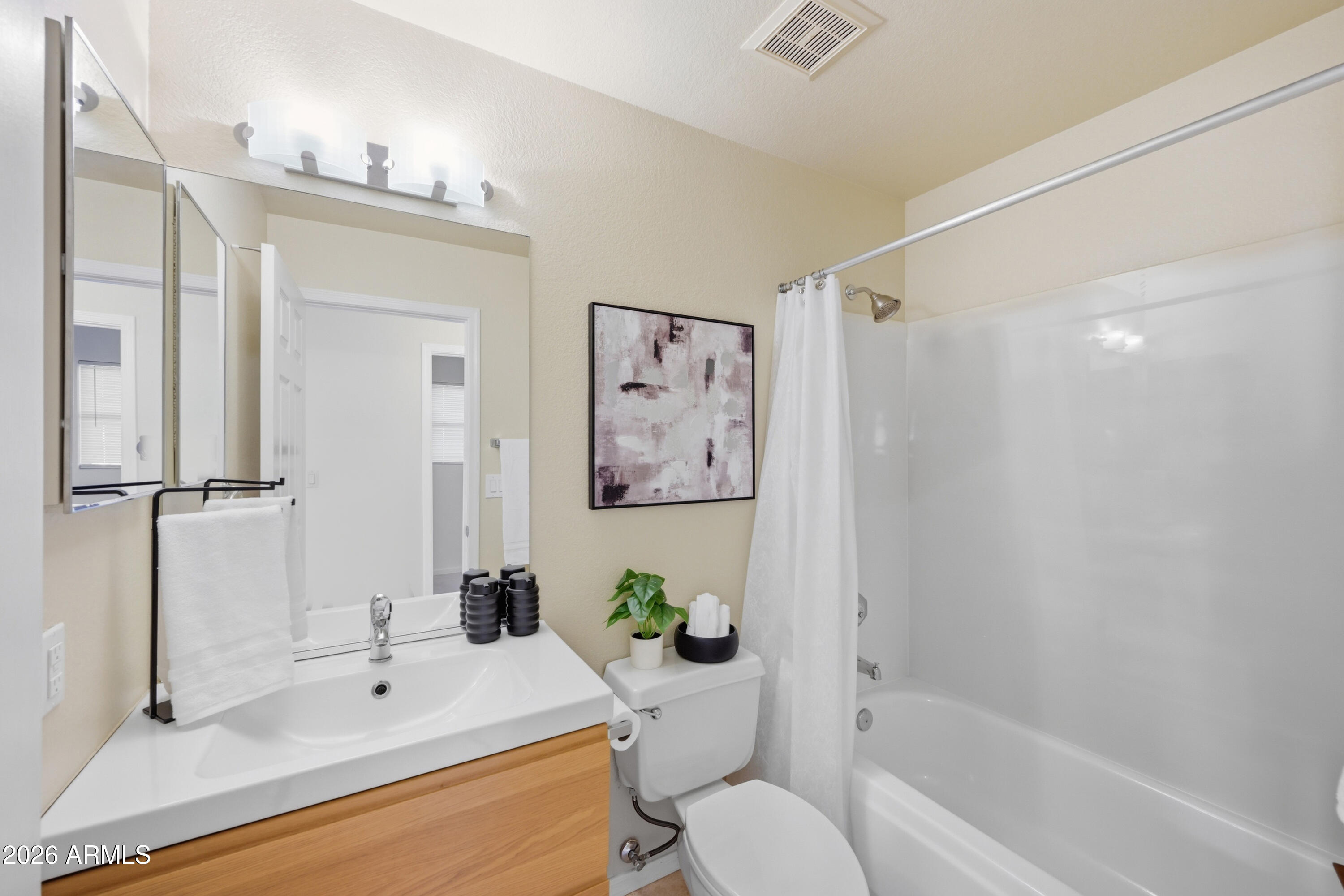 9502 East Presidio Road Scottsdale, AZ 85260 - Photo 15 of 39 a bathroom with a bathtub a sink and a large mirror