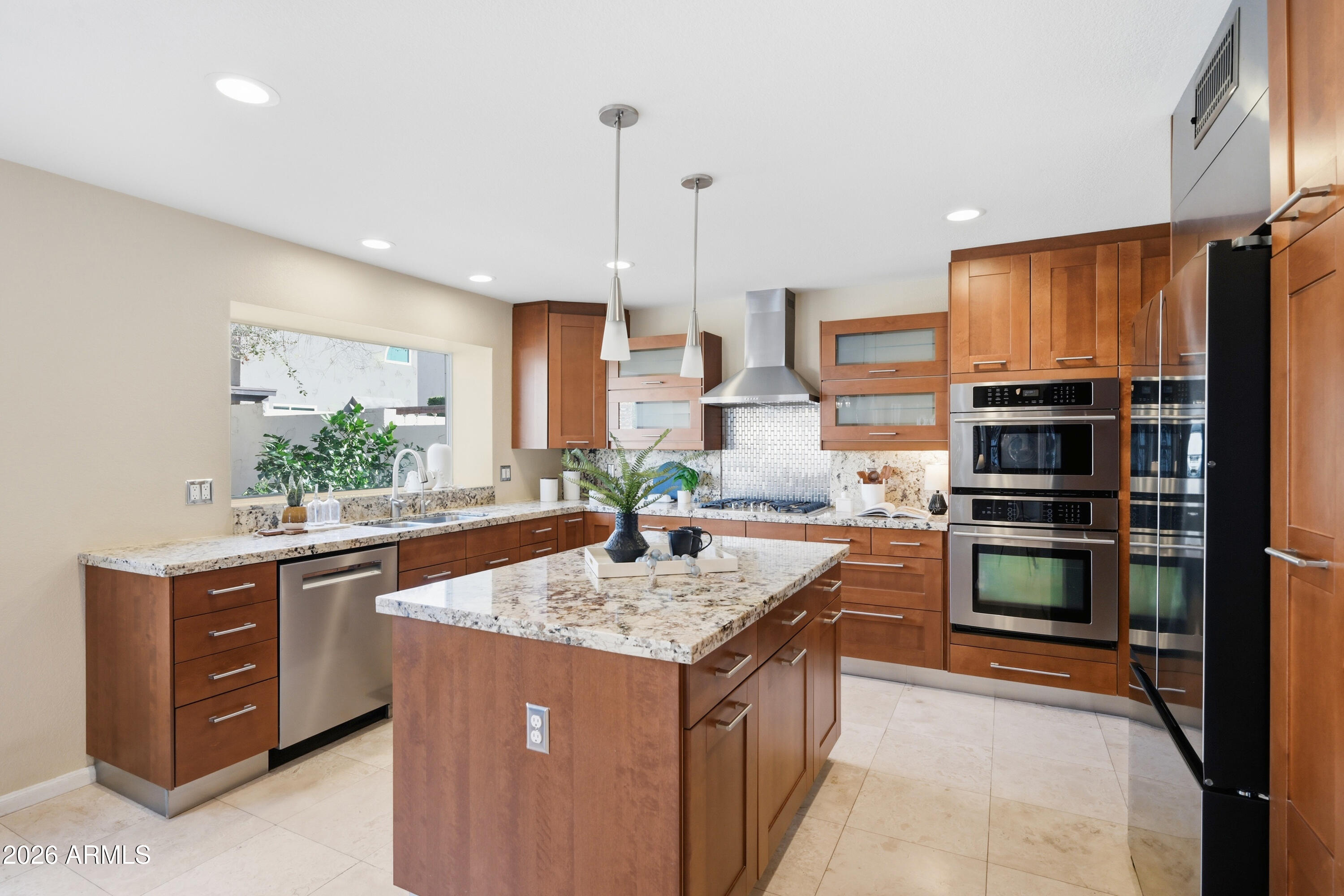 9502 East Presidio Road Scottsdale, AZ 85260 - Photo 16 of 39 a kitchen with stainless steel appliances granite countertop a stove a sink and a refrigerator