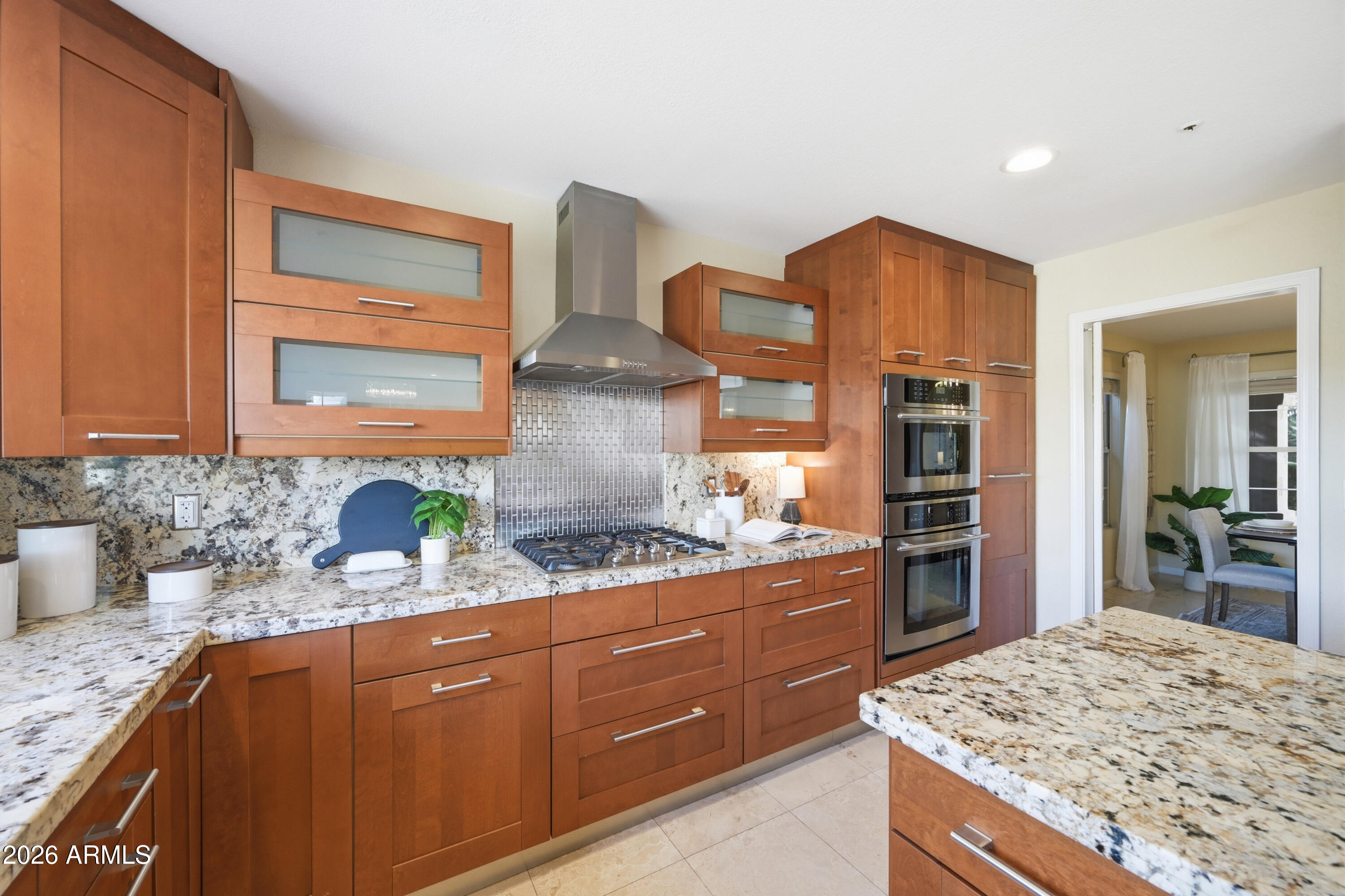 9502 East Presidio Road Scottsdale, AZ 85260 - Photo 18 of 39 a kitchen with stainless steel appliances granite countertop wooden cabinets and a refrigerator