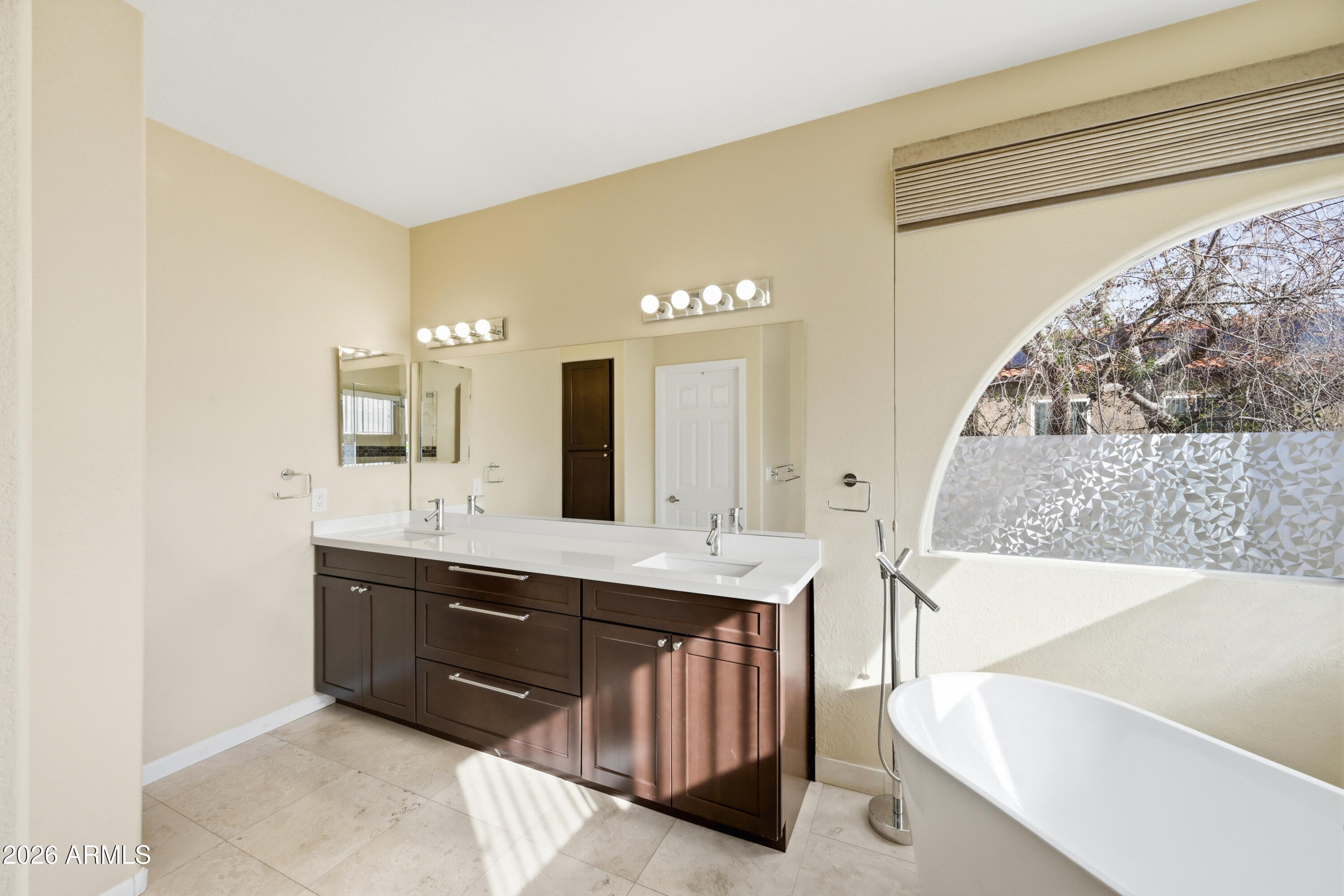 9502 East Presidio Road Scottsdale, AZ 85260 - Photo 27 of 39 a spacious bathroom with a tub sink and mirror