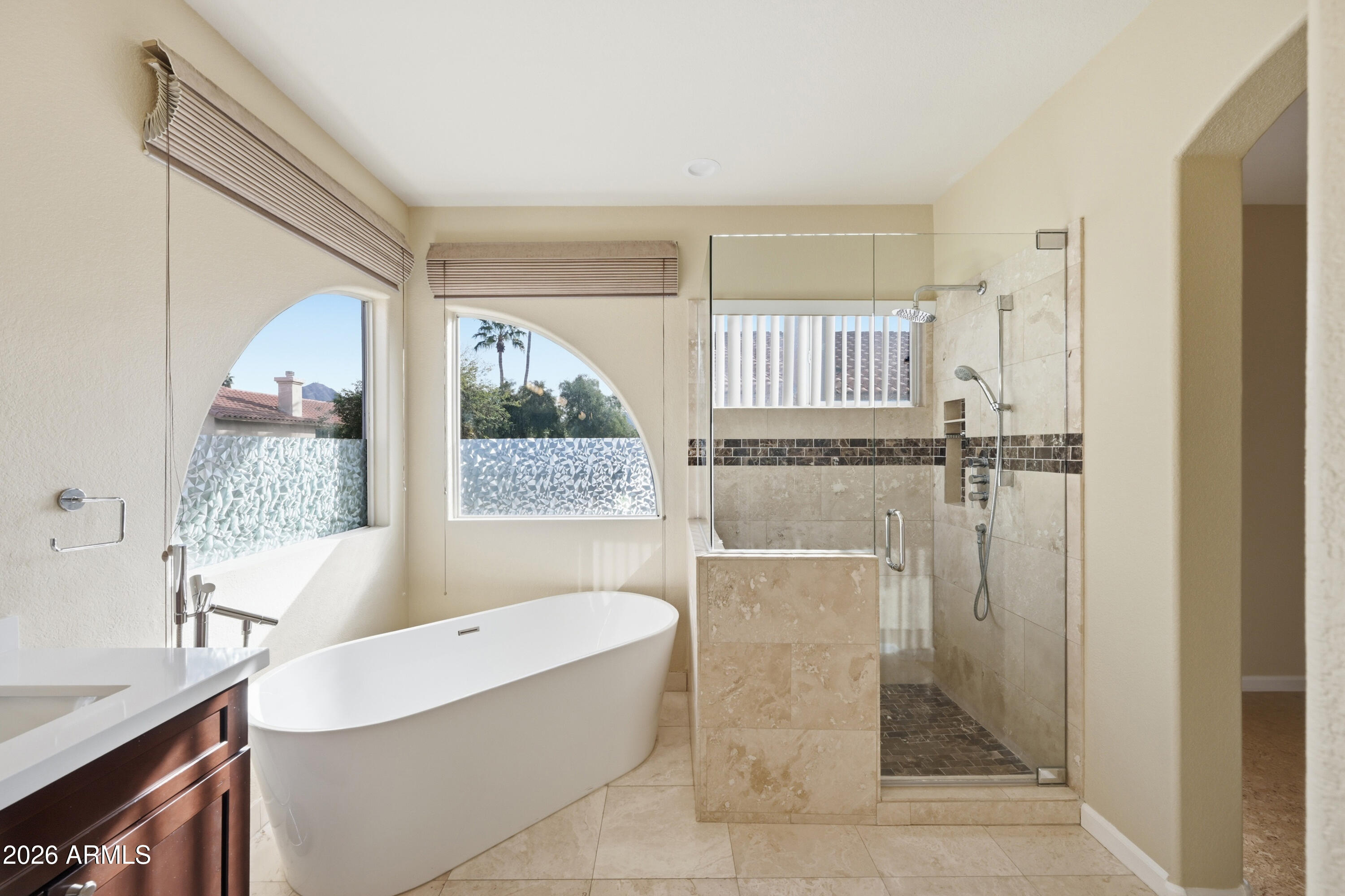 9502 East Presidio Road Scottsdale, AZ 85260 - Photo 5 of 39 a bathroom with a tub sink and mirror