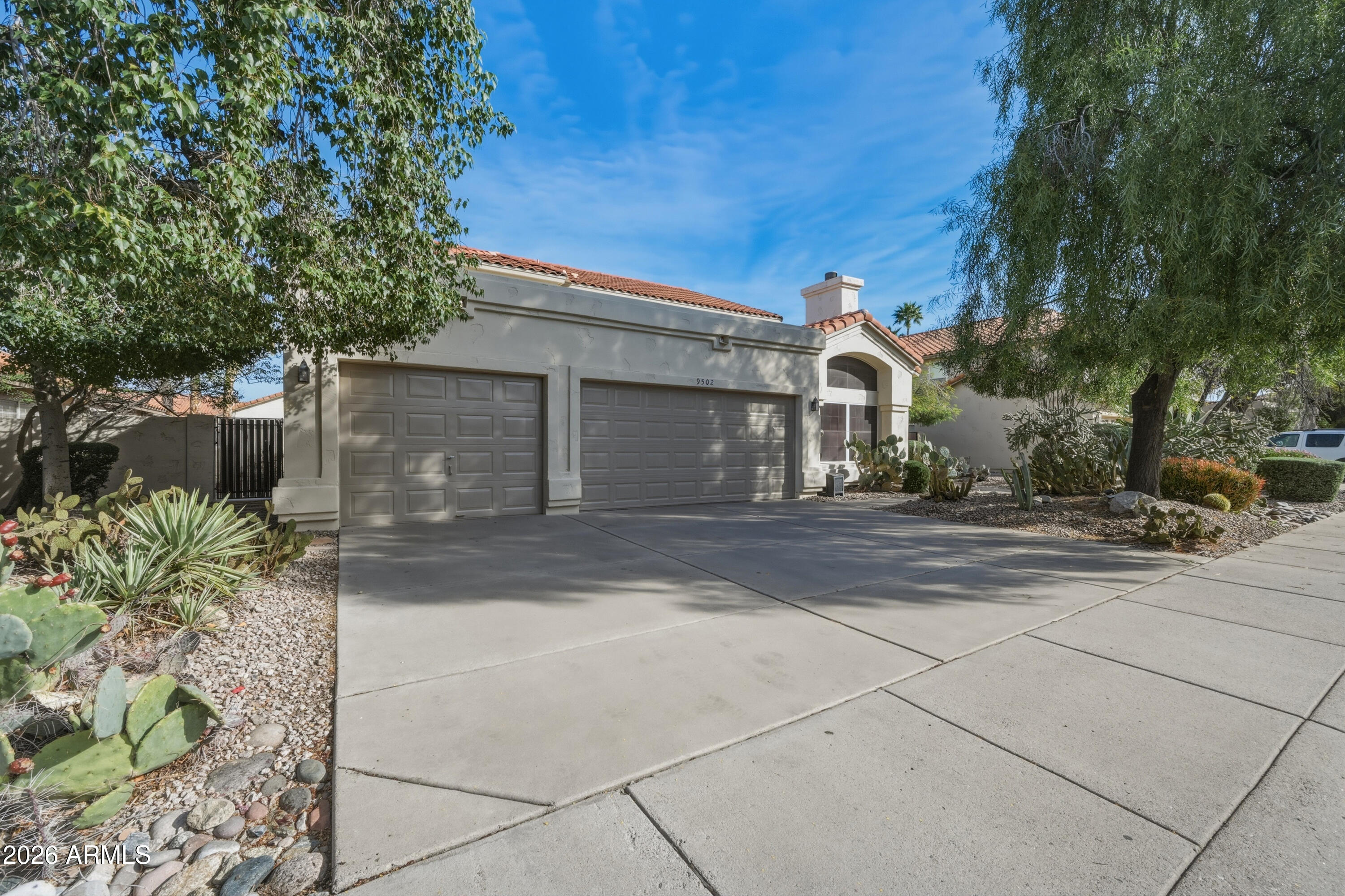 9502 East Presidio Road Scottsdale, AZ 85260 - Photo 8 of 39 a front view of a house with a yard and garage