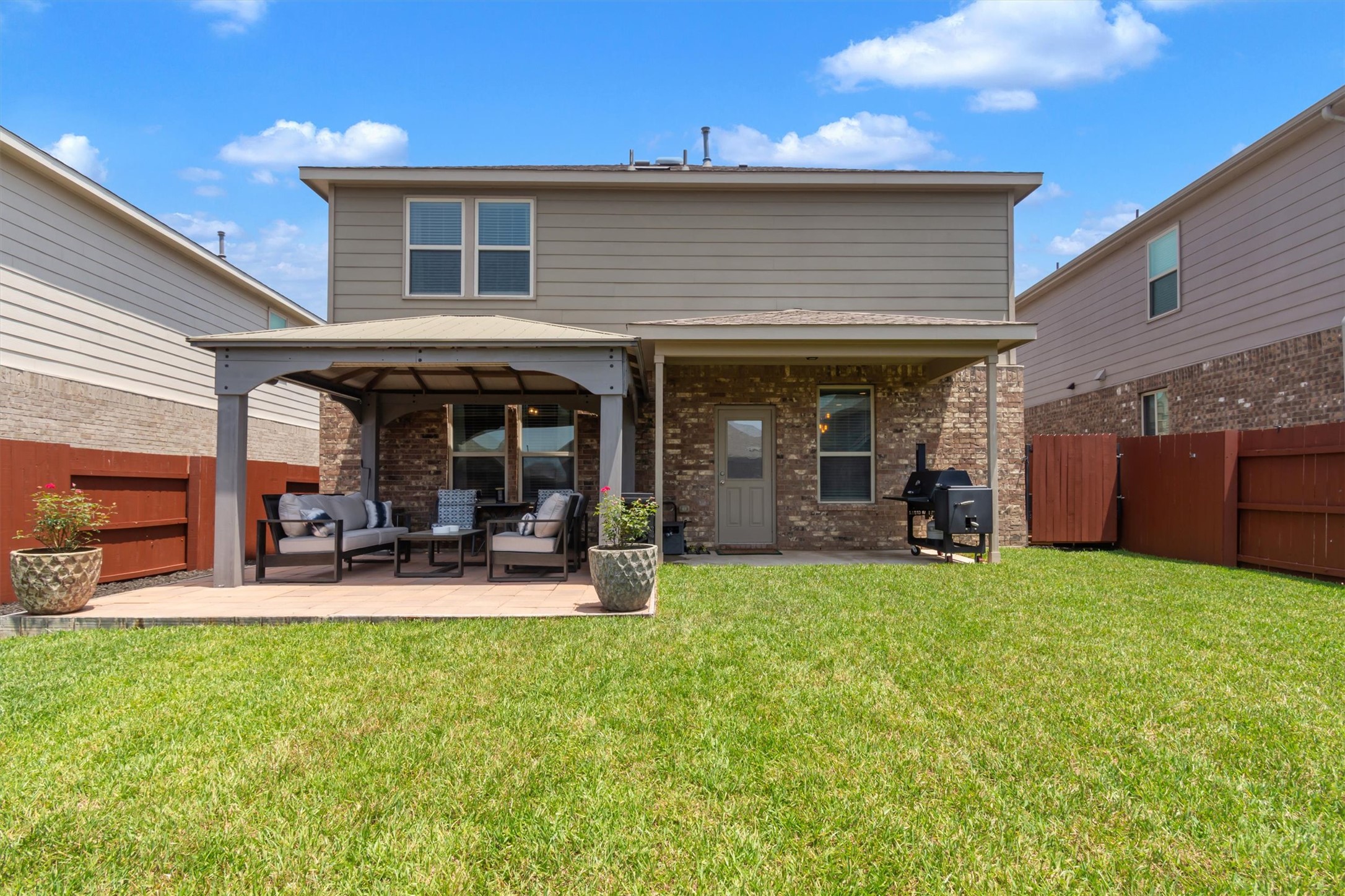 11701 Jackson Falls Way Manor, TX 78653 - Photo 5 of 40 Enjoy outdoor living with a covered patio for entertaining and a lush green yard.