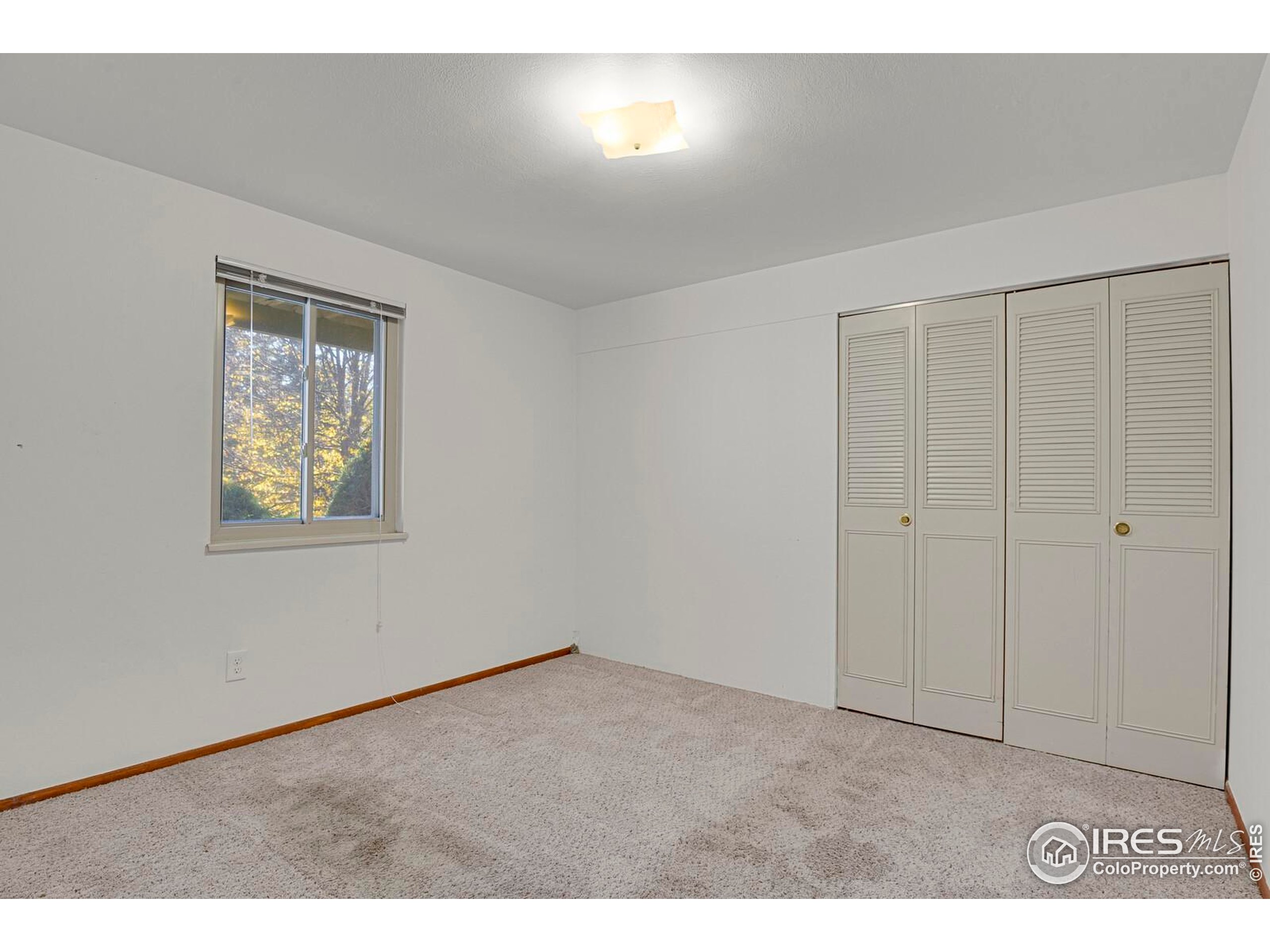 8050 Niwot Road, Unit 1 Niwot, CO 80503 - Photo 10 of 20 a view of an empty room with a window