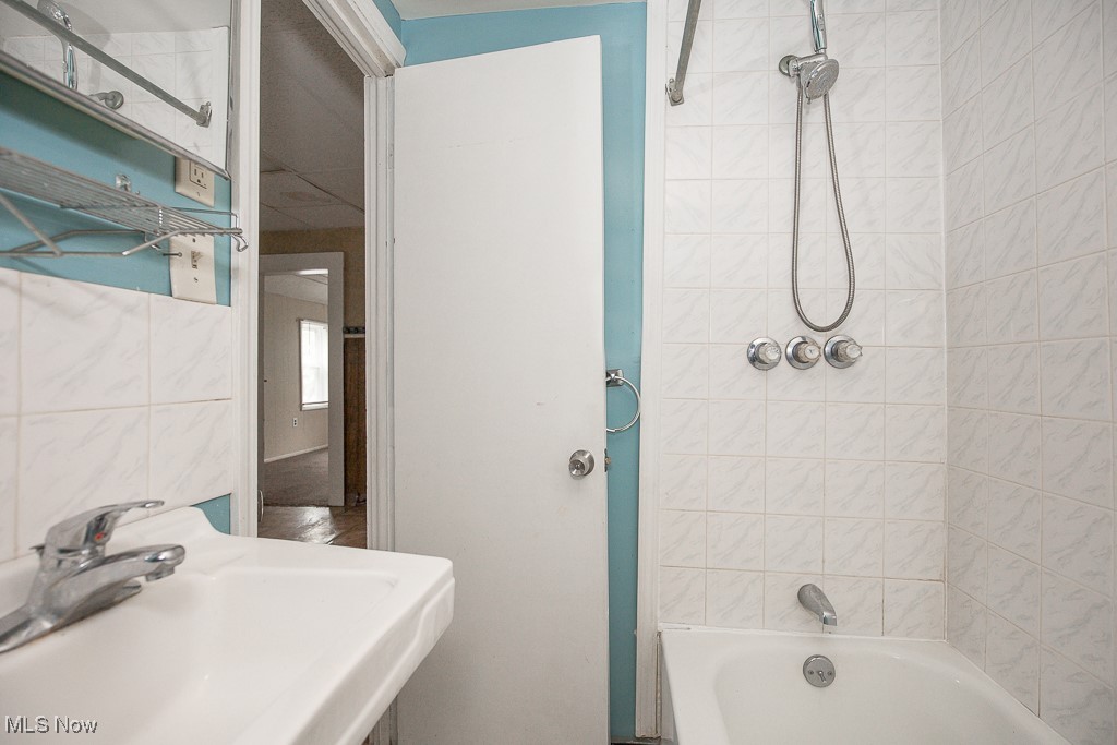 5008 Dolloff Road Cleveland, OH 44127 - Photo 12 of 16 Bathroom with a sink and bathing tub / shower combination