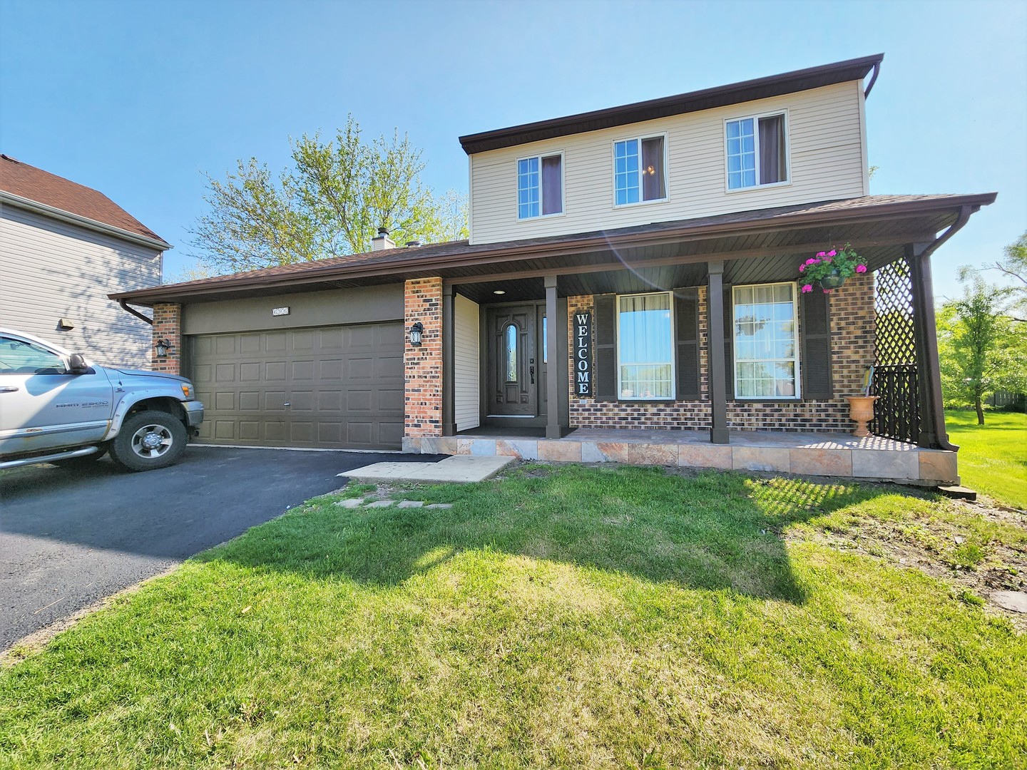 a front view of a house with a yard and garage